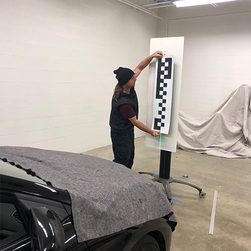 defender employees repairing auto glass