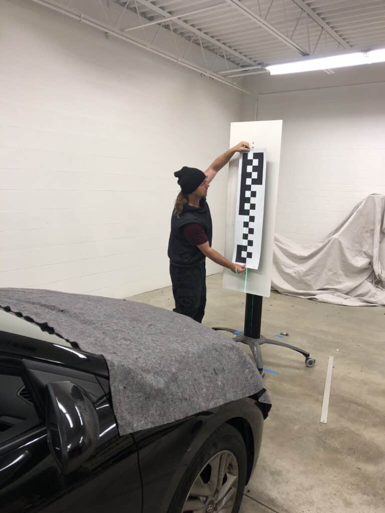 defender employees repairing auto glass